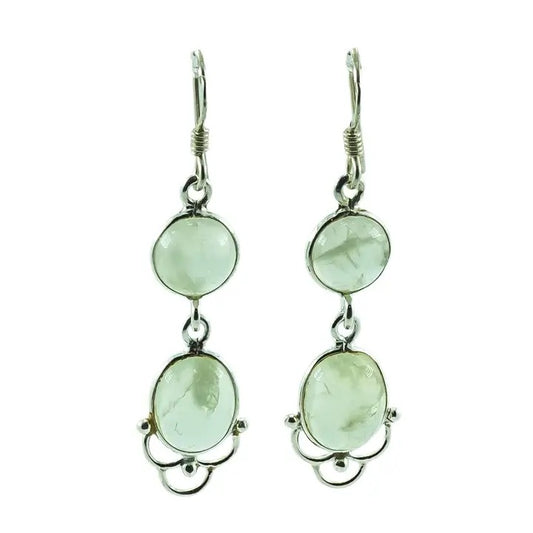 Pair of earrings with green gemstones on a white background