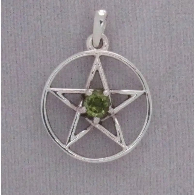 Silver pentacle pendant with a green gemstone on a gray background
