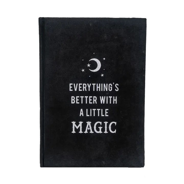 Black notebook with 'Everything's better with a little magic' text and celestial design on a white background