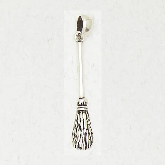 Silver broom charm on a white background
