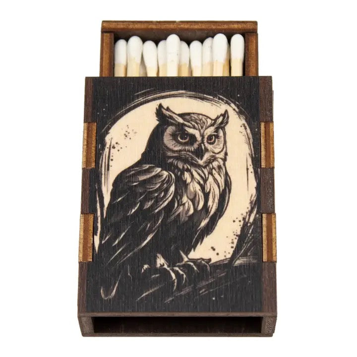 Matchbox with owl design on a white background