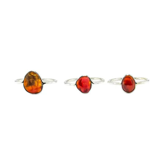 Three amber stone rings on a white background