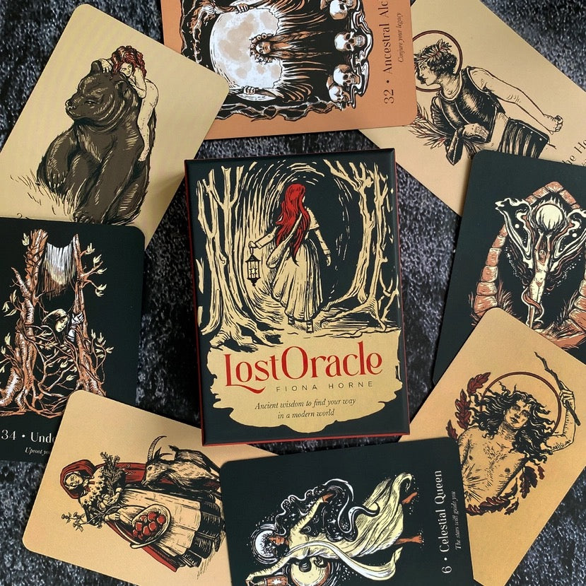 Collection of 'Lost Oracle' cards with artistic illustrations on a dark surface