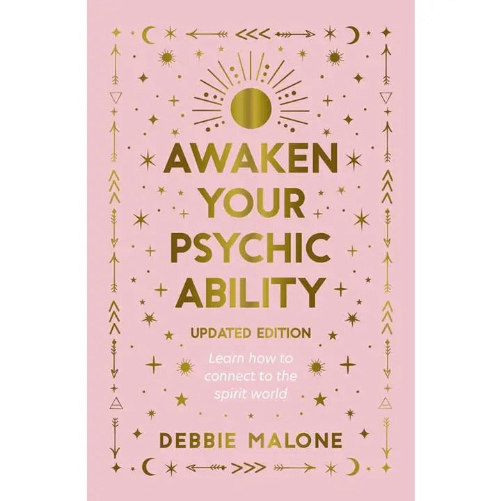 Awaken Your Psychic Ability written in gold on book cover on a pink cover