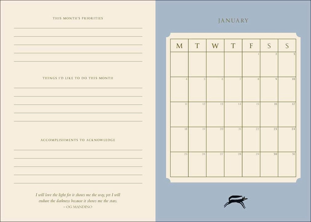 A monthly planner or calendar spread showing January on the right with a cream grid on a muted blue background, and lined writing sections on the left with the heading 'This Month's Priorities' and a quote at the bottom.
