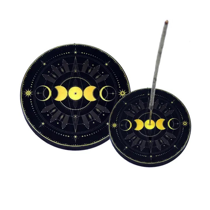 Incense sticks with decorative holder featuring moon phases on a white background