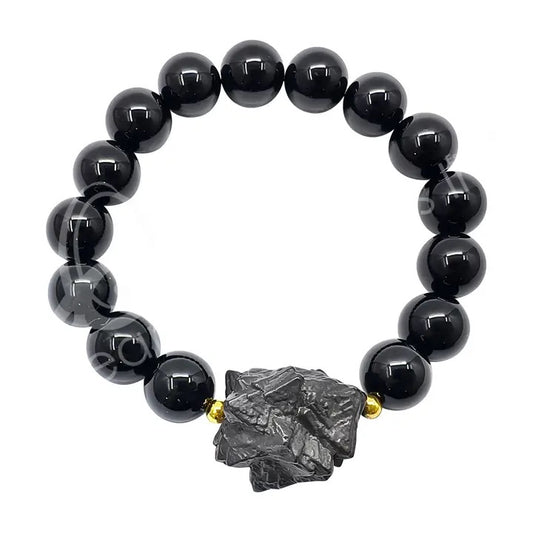 Black beaded bracelet with a large dark stone clasp on a white background