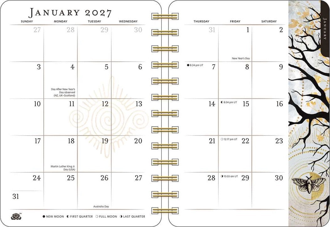January 2027 monthly calendar spread from a spiral-bound planner, showing a white page layout with gold grid lines, decorative moon phases, and a black-and-gold tree illustration on the right edge.