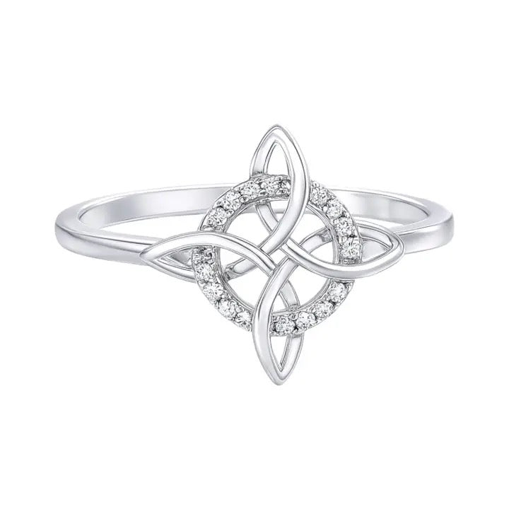A silver-toned ring featuring a Celtic knot design with a central circle paved with small clear stones, shown on a plain white background.