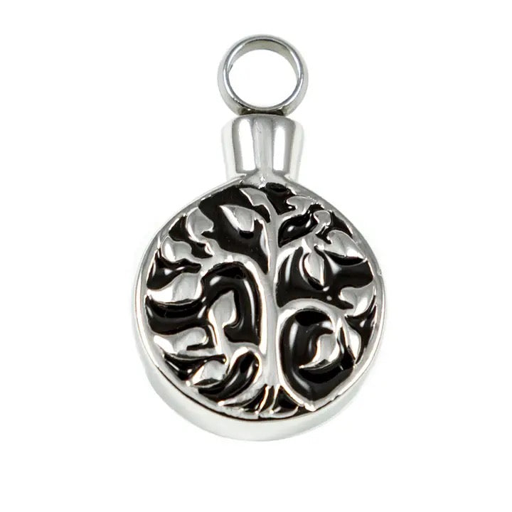 Silver pendant with tree of life design on a white background