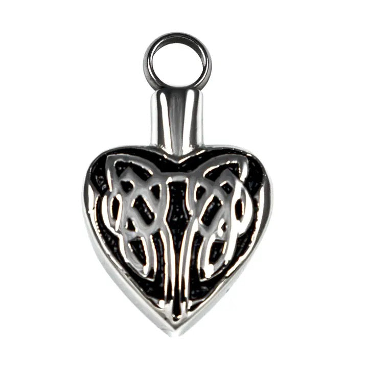 Silver heart-shaped pendant with intricate design on a white background