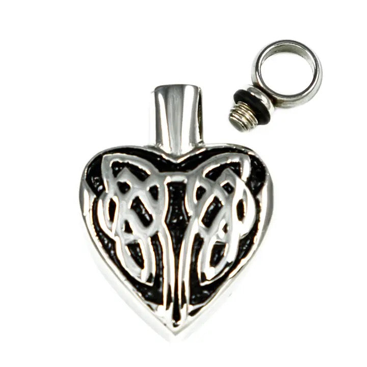 Silver heart-shaped pendant with Celtic knot design on a white background