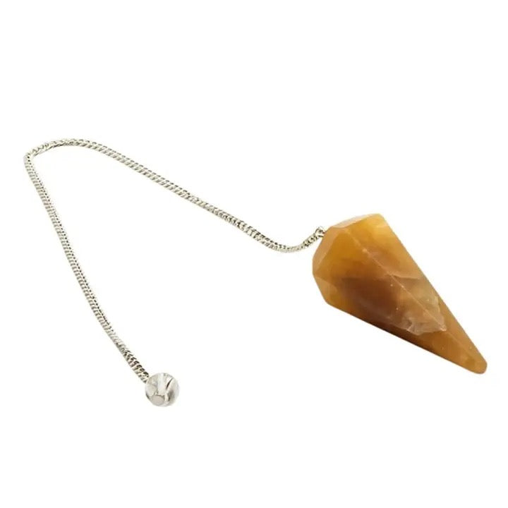 golden Healer pendulum on silver chain on white background