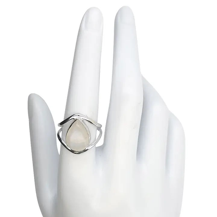 Silver ring with a teardrop-shaped moonstone on a white hand model