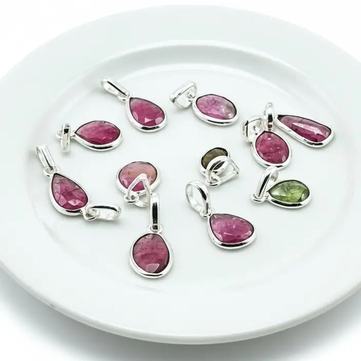 Assorted Pendant Tourmaline Watermelon Freeform on a white plate 