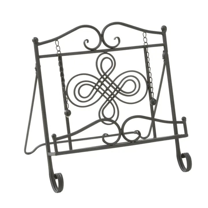 Black wrought iron book stand with decorative scrollwork and hanging chains, shown on a plain white background.