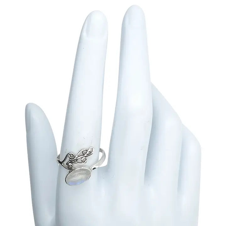 Silver ring with a moonstone on a white hand model