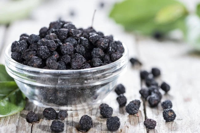 Aronia Berry Dried purple in a glass bowl