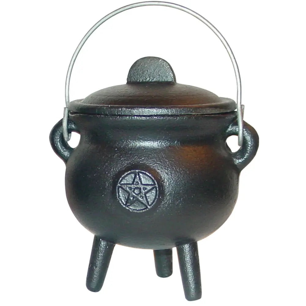 Black cast iron cauldron with a pentagram symbol on a white background