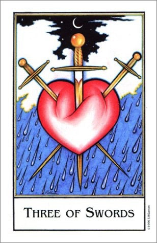 A tarot card titled 'Three of Swords' showing a red heart pierced by three swords, with blue rain-like drops below and a black sky with a crescent moon above.