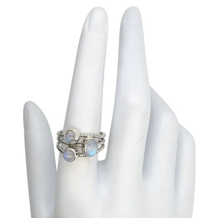 Silver ring with moonstone on a white hand model