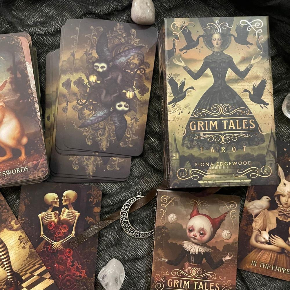Grim Tales Tarot cards on a dark fabric background