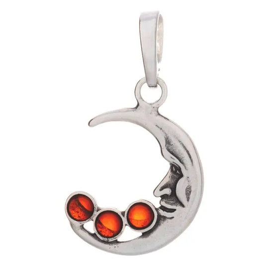 A silver crescent moon pendant featuring a stylized face and three round amber-colored gemstones, shown on a plain white background.