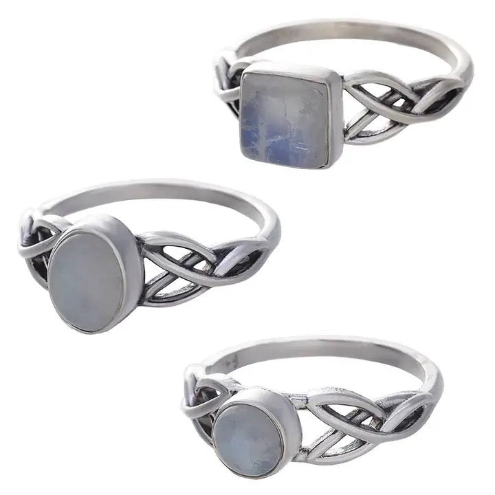 Three silver rings with moonstone stones on a white background