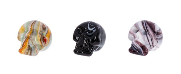 Three marbled glass knobs in different colors on a white background