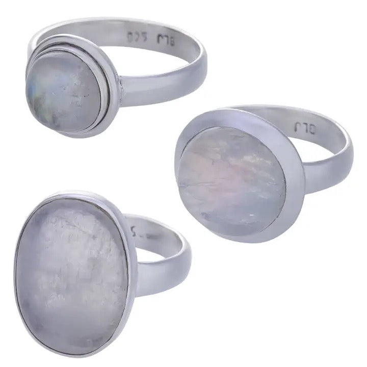 Three silver rings with moonstone stones on a white background