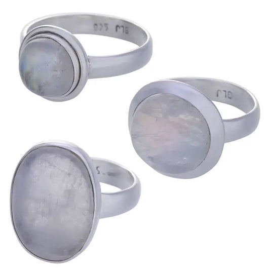 Three silver rings with moonstone stones on a white background