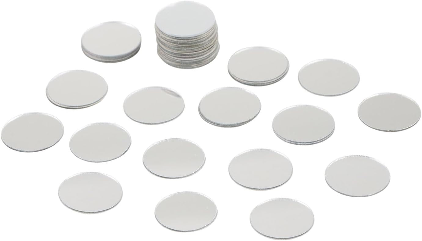 A set of round silver mirror discs, with one small stack and many individual discs arranged on a plain white background.
