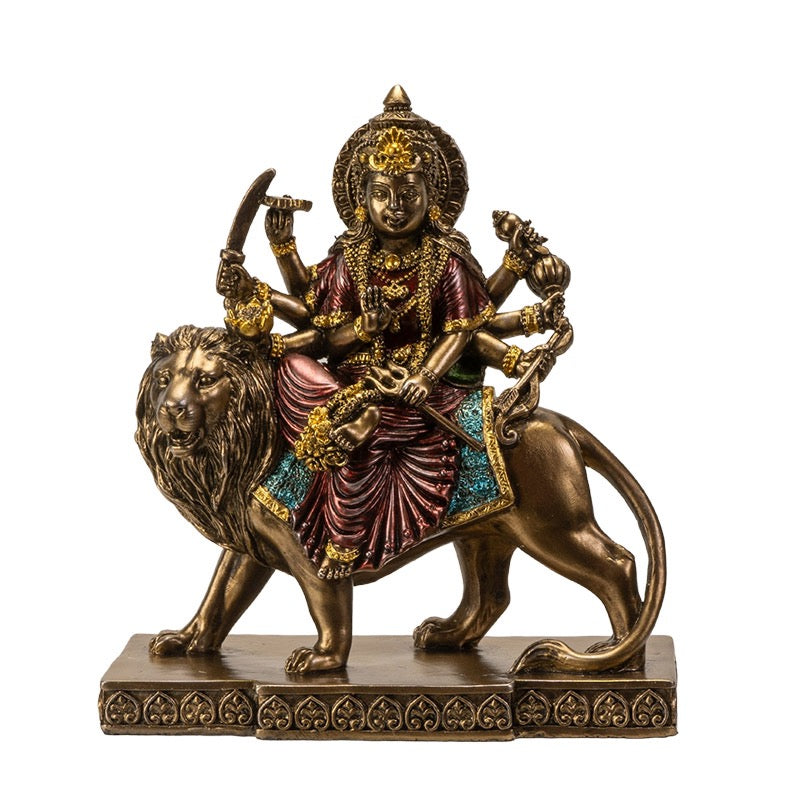 Statue of a deity riding a lion on a white background