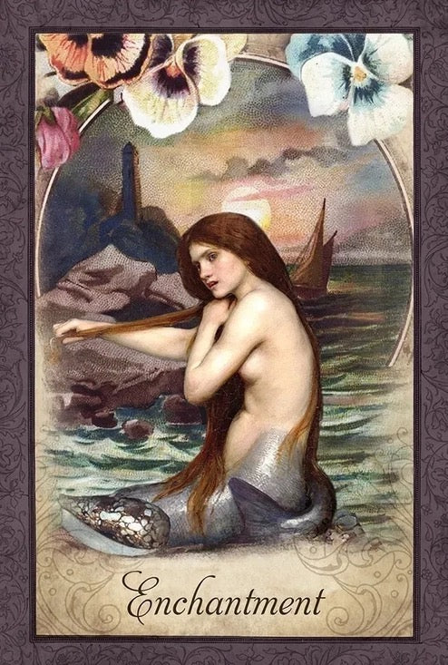 Mermaid sitting on a rock with flowers and a ship in the background, titled 'Enchantment'.