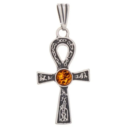 A sterling silver ankh pendant featuring intricate engravings and a central round amber gemstone, shown against a plain white background.
