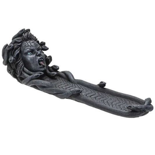 Decorative incense burner with a face and flowing design on a white background