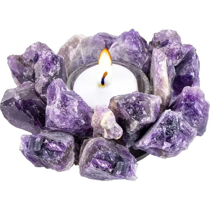 Candle holder made of purple amethyst crystals on a white background