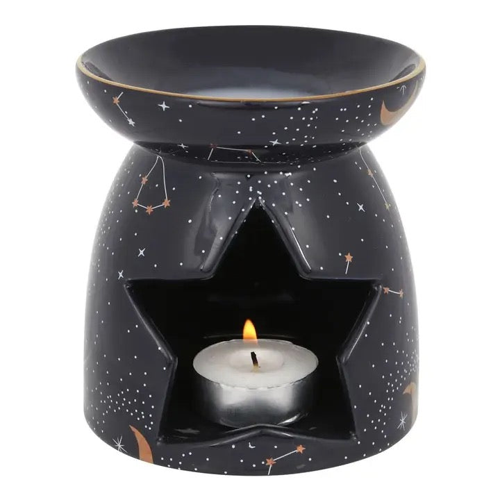 Oil Diffuser Constellation Purple with a lit candle