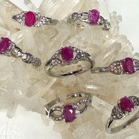 Silver rings with pink gemstones on a crystal background