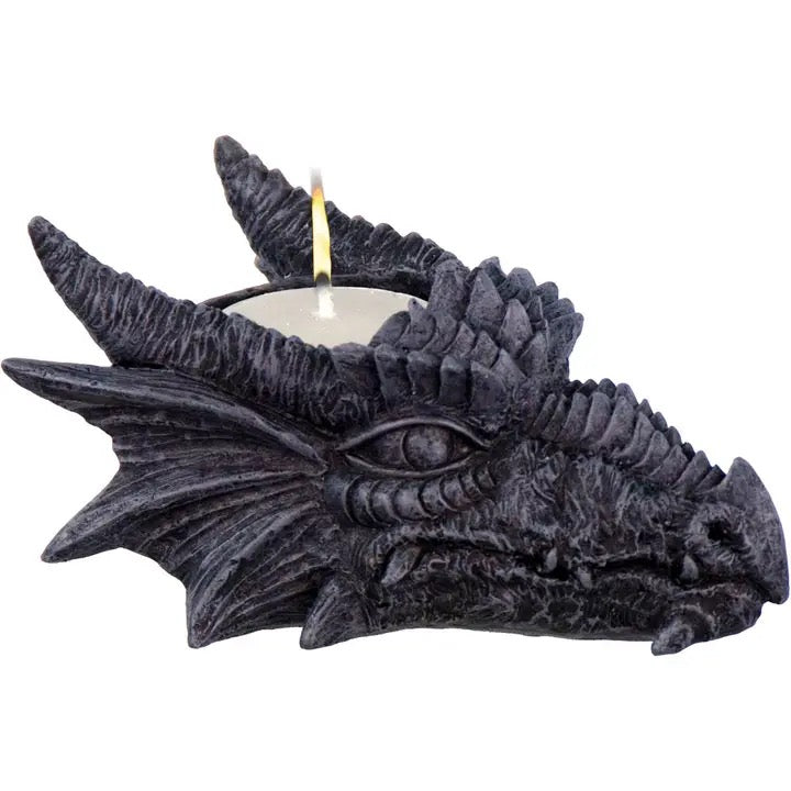 Dragon-shaped candle holder with a lit candle on a white background