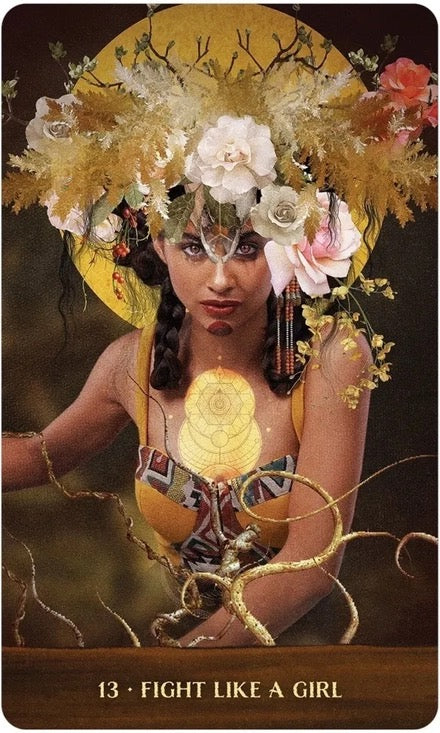 Woman with floral headpiece and accessories, with text '13 - Fight Like a Girl' at the bottom.