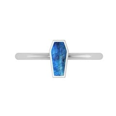 Silver ring with a blue stone on a white background