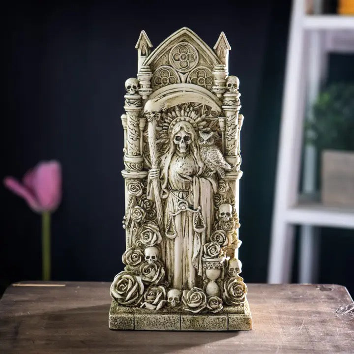 Decorative skeleton figurine with ornate design on a wooden surface