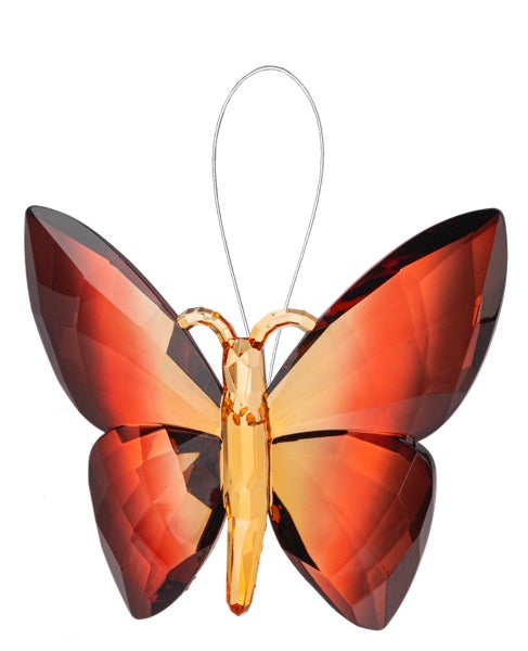 Butterfly-shaped ornament with red and orange wings on a white background