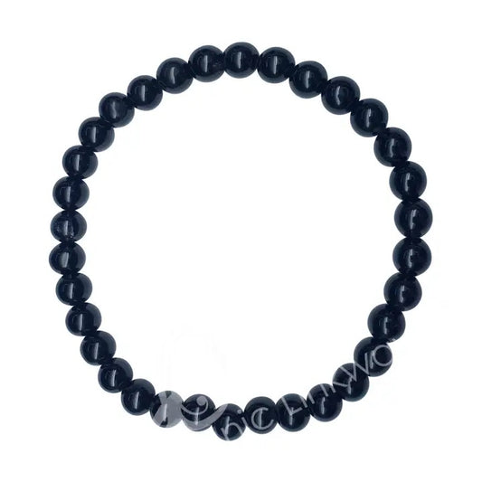 Black beaded bracelet with engraved text on a white background