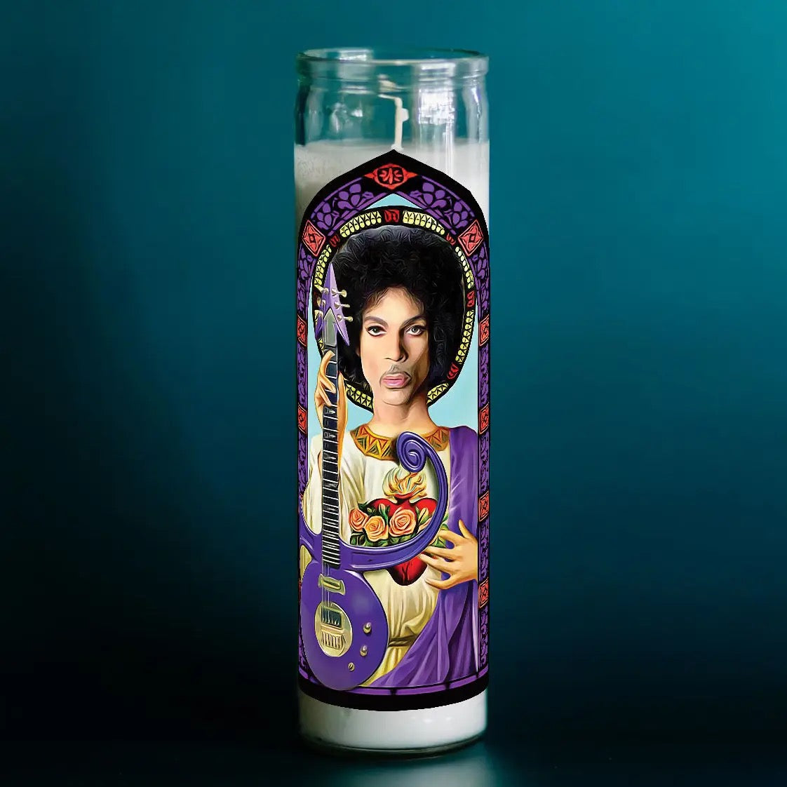 Candle with a decorative cover featuring a portrait and guitar on a dark background