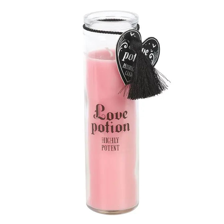 Pink candle labeled 'Love potion Highly Potent' with decorative hearts on a white background