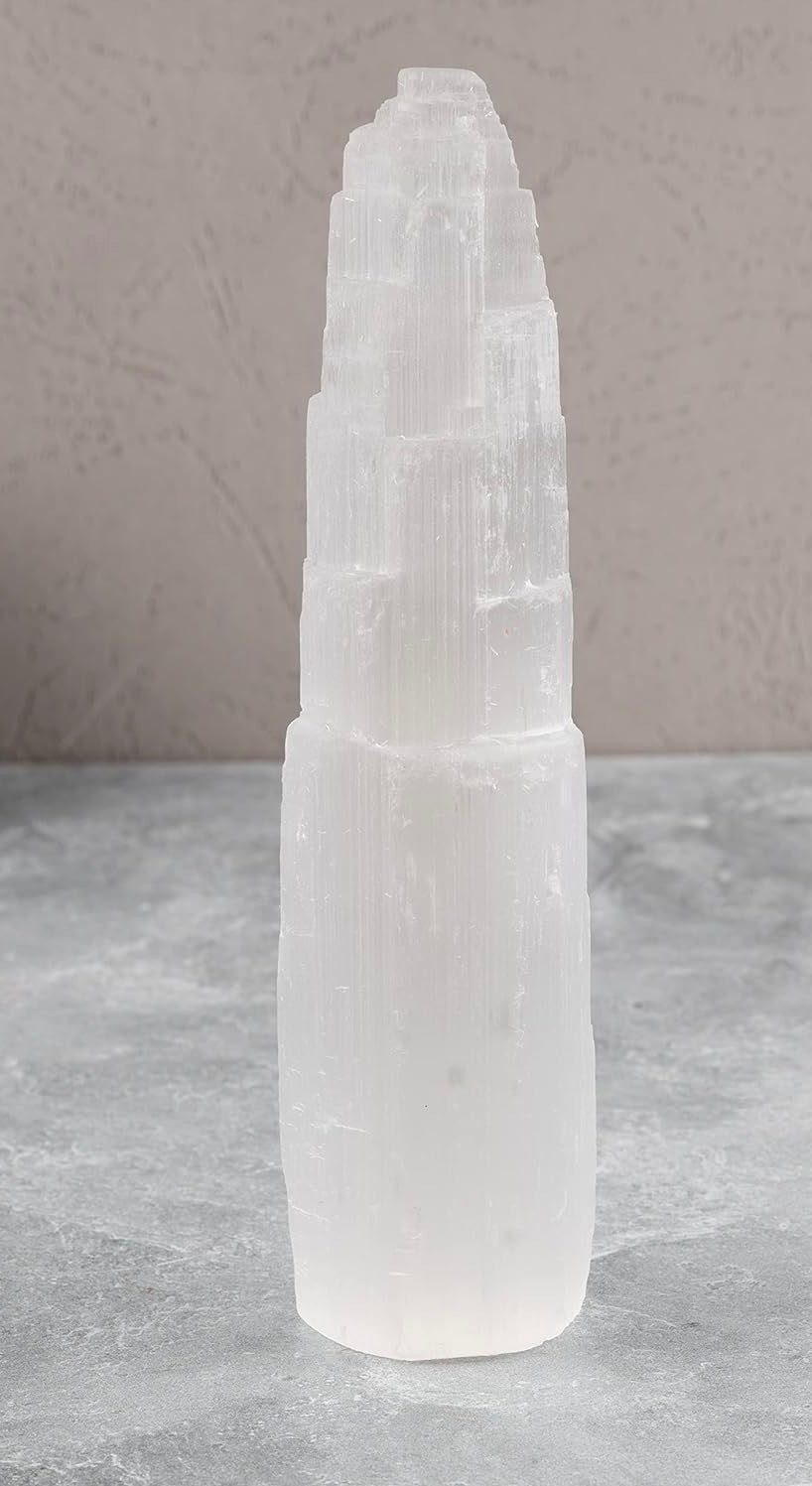 Tall, white crystal tower on a gray surface with a neutral background