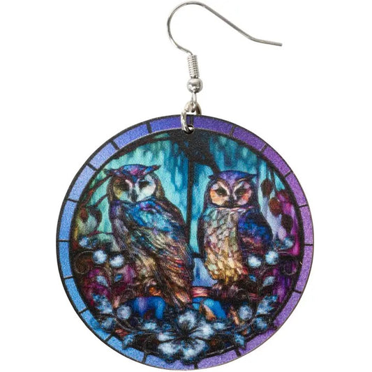 Earrings with owl design in a circular frame on a white background