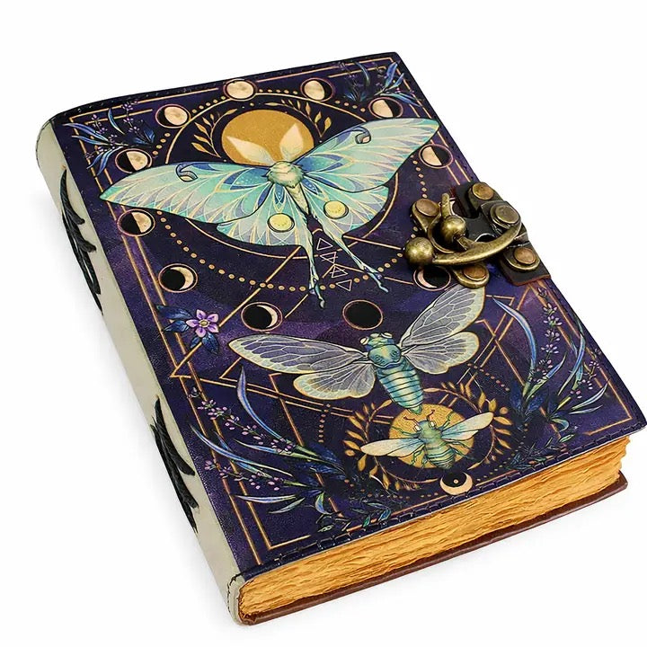 Decorative notebook with moths design and brass clasp on a white background